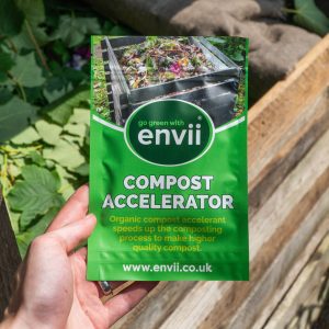 Compost Accelerator situated in front of a compost heap.